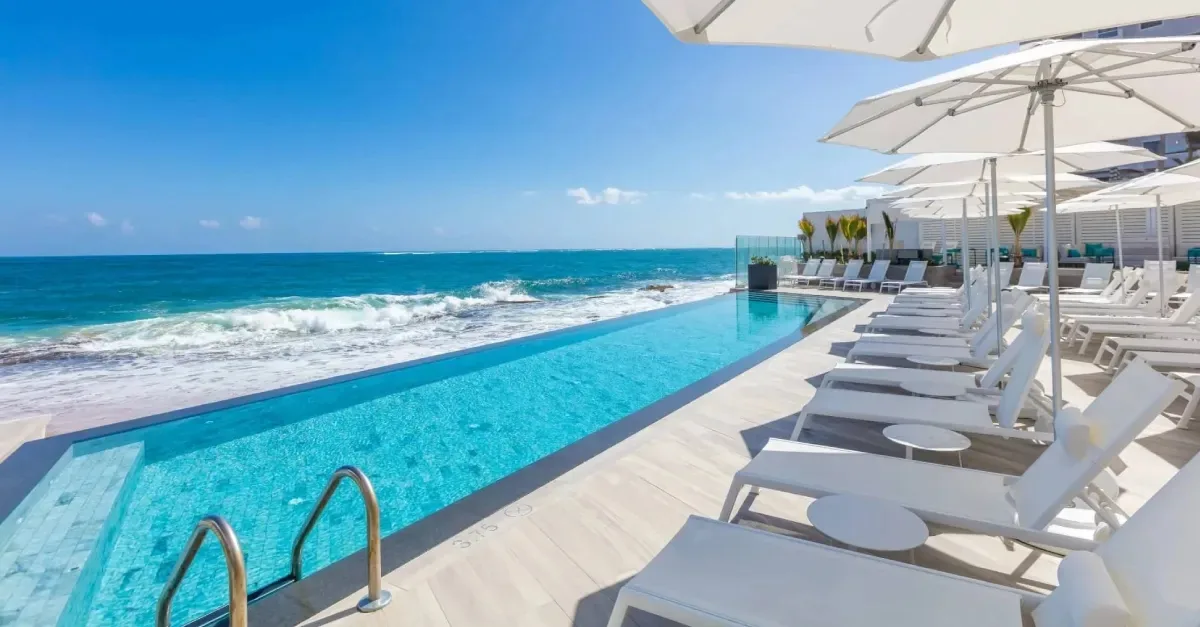Oceanfront swimming pool and lounge chairs at Condado Ocean Club.