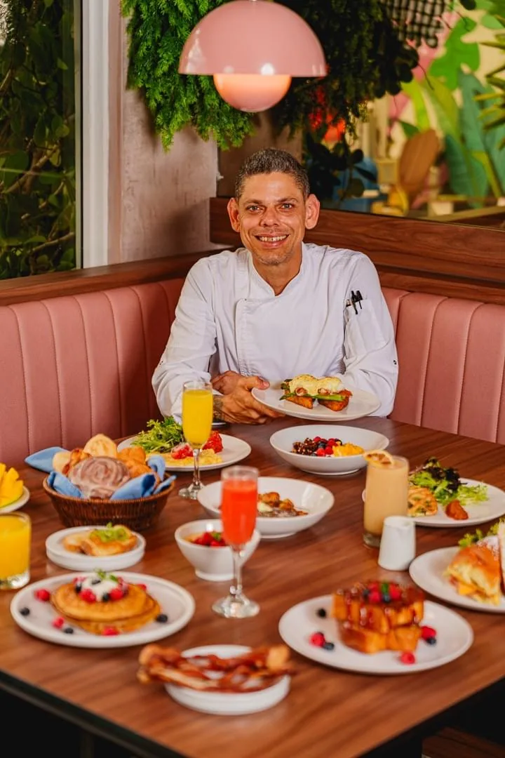 A table of plated dishes and drinks inside El Condado Gastrobar.