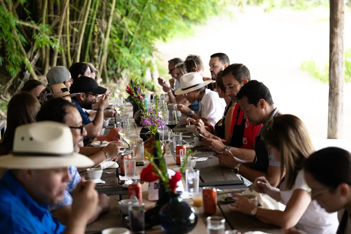 Guests sharing a meal at a long table at Finca La Zafra