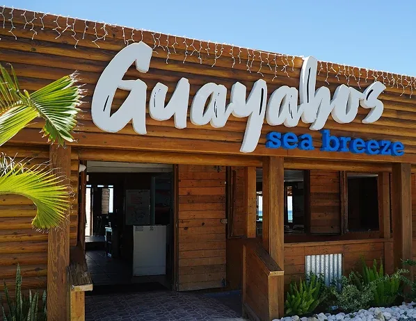 Wooden entrance and sign at Guayabo’s Sea Breeze in Aguada.