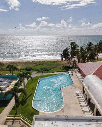Pool and Caribbean shoreline seen from Parador MaunaCaribe