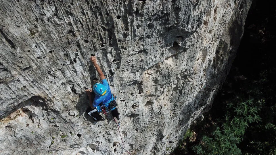 A climber on a limestone wall at Roca Norte Outdoor Climbing Gym.